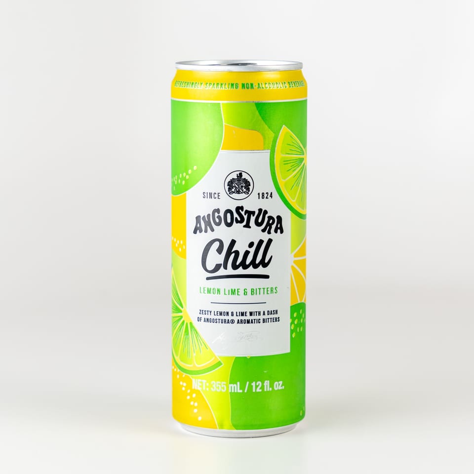 Angostura Chill Lemon Lime & Bitters sparkling non-alcoholic beverage can with citrus slices.