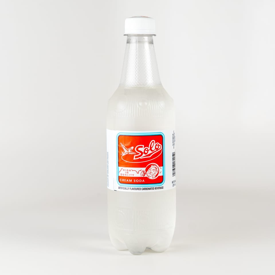 A bottle of Solo Cream Soda, a popular Caribbean carbonated beverage, on a white background.