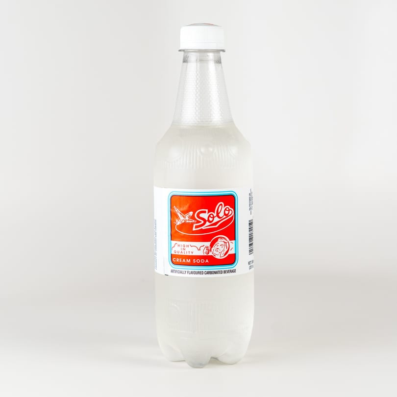 A bottle of Solo Cream Soda, a popular Caribbean carbonated beverage, on a white background.